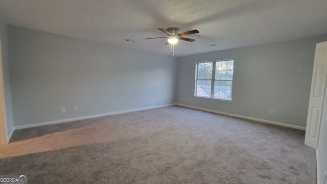 empty room featuring carpet and ceiling fan