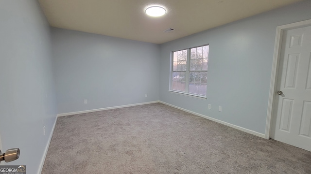 unfurnished room featuring light colored carpet