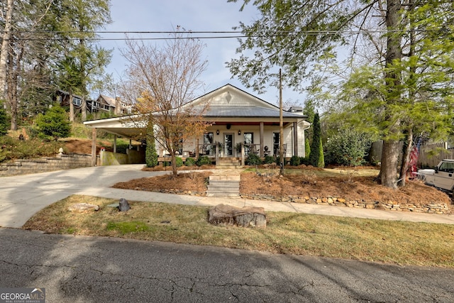 view of front of house with covered porch and a carport