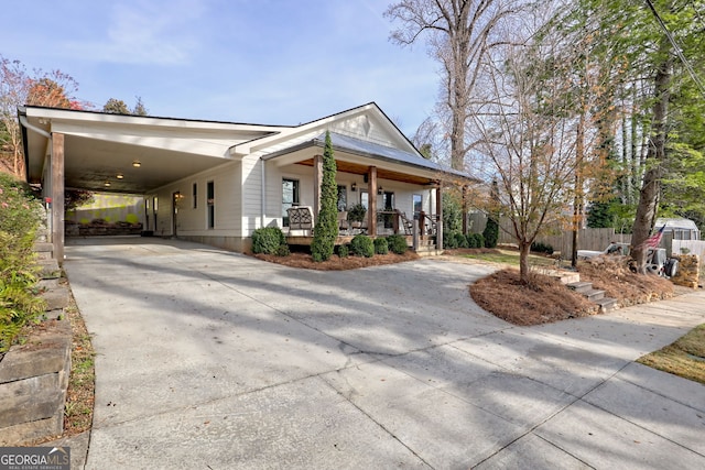 view of front of house featuring a porch and a carport