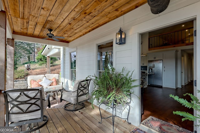 wooden deck featuring ceiling fan