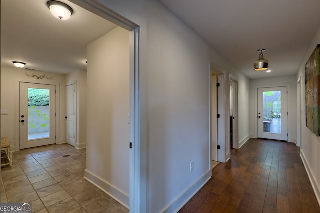 hall featuring a healthy amount of sunlight and hardwood / wood-style floors