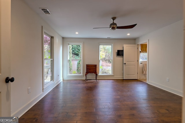 empty room featuring ceiling fan and dark hardwood / wood-style flooring