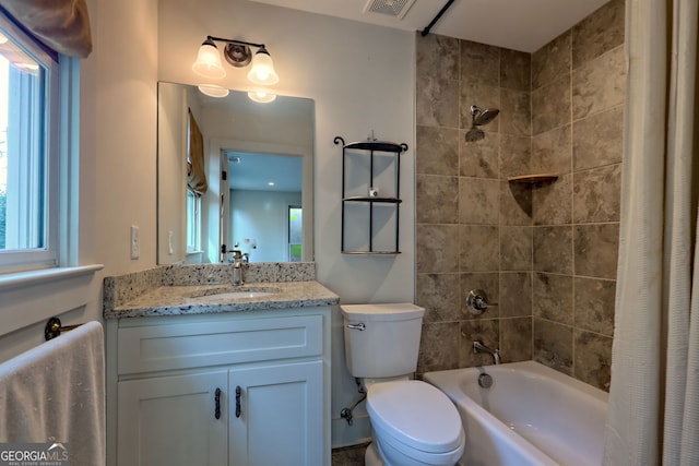 full bathroom featuring a wealth of natural light, toilet, vanity, and shower / bathtub combination with curtain