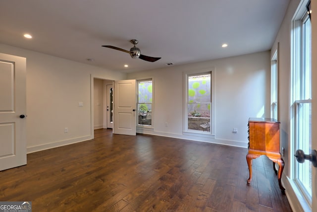 interior space with dark wood-type flooring and ceiling fan