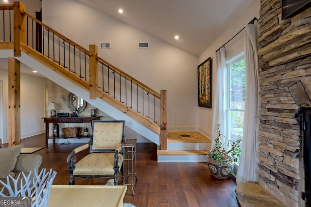 interior space with high vaulted ceiling and wood-type flooring