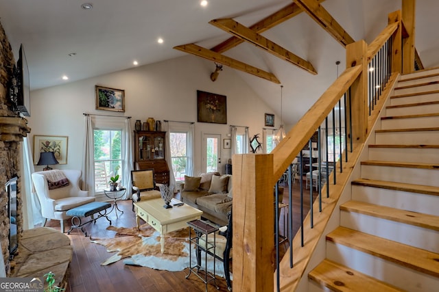 living room featuring high vaulted ceiling, hardwood / wood-style flooring, and beamed ceiling