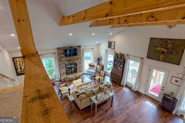 living room featuring high vaulted ceiling, dark wood-type flooring, beamed ceiling, and a stone fireplace