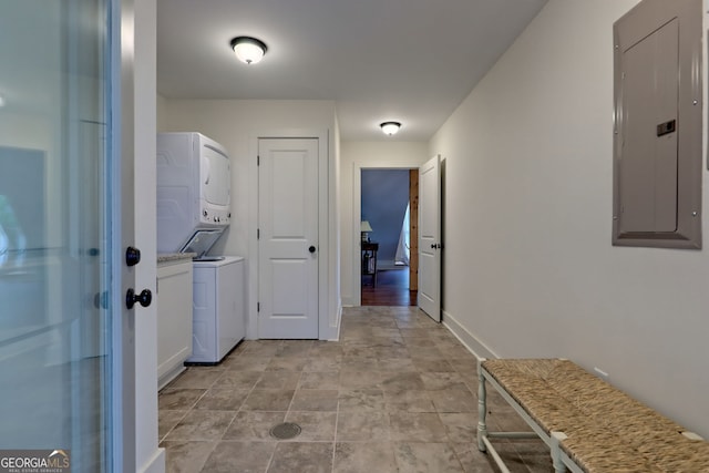 laundry area with stacked washing maching and dryer and electric panel