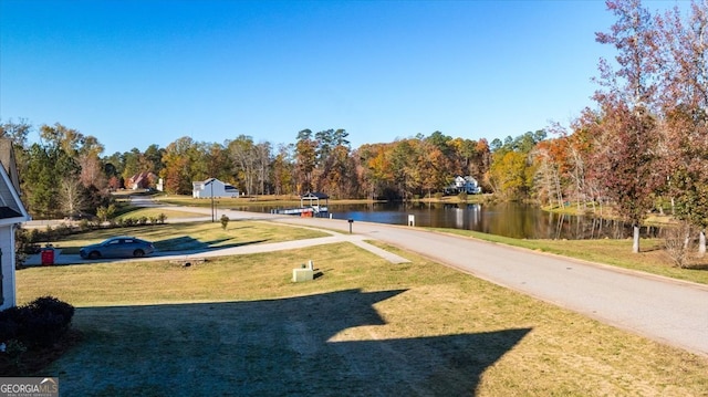 exterior space with a lawn and a water view