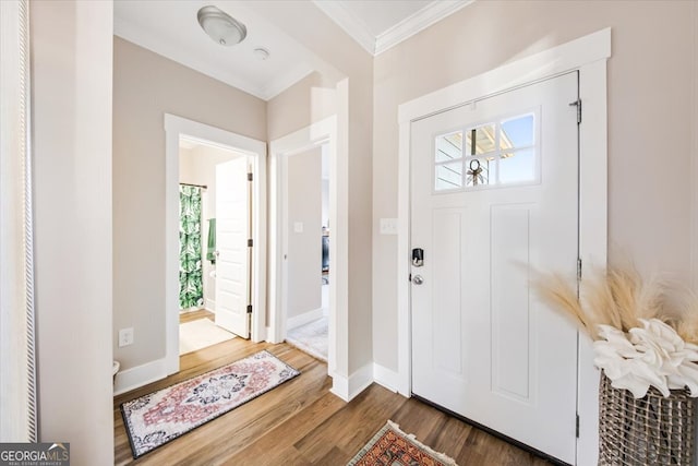 foyer featuring dark hardwood / wood-style floors and ornamental molding