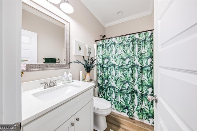 bathroom with ornamental molding, a shower with curtain, vanity, hardwood / wood-style flooring, and toilet