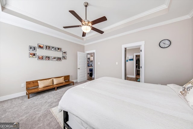 carpeted bedroom featuring ceiling fan, a raised ceiling, and crown molding