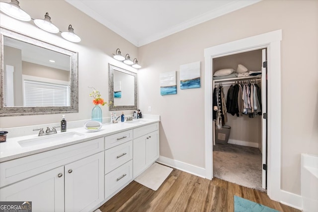 bathroom with hardwood / wood-style floors, vanity, and crown molding