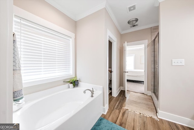 bathroom with hardwood / wood-style flooring, a healthy amount of sunlight, crown molding, and plus walk in shower