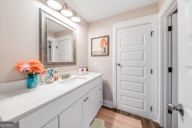 bathroom with hardwood / wood-style floors and vanity