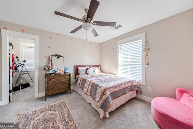 bedroom featuring ceiling fan and light carpet