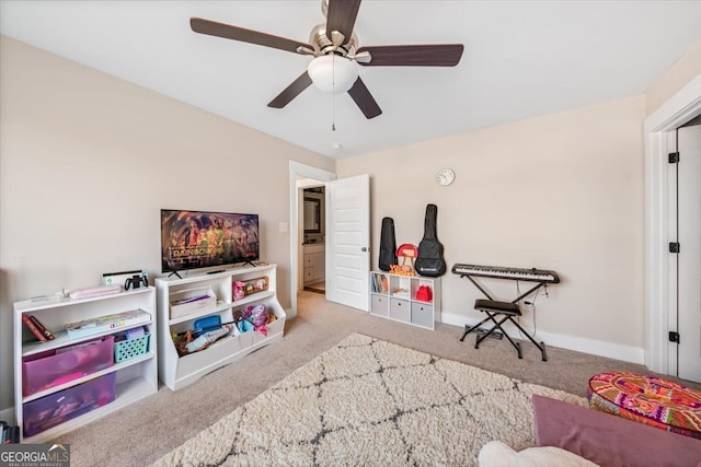 recreation room with light colored carpet and ceiling fan