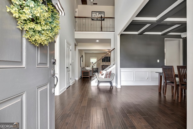 foyer featuring beam ceiling, dark wood-type flooring, and coffered ceiling