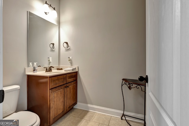 bathroom featuring tile patterned floors, vanity, and toilet