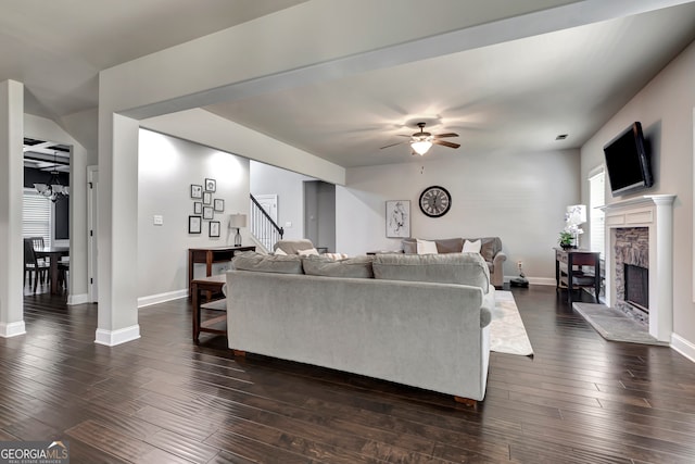 living room with ceiling fan, dark hardwood / wood-style flooring, and a fireplace