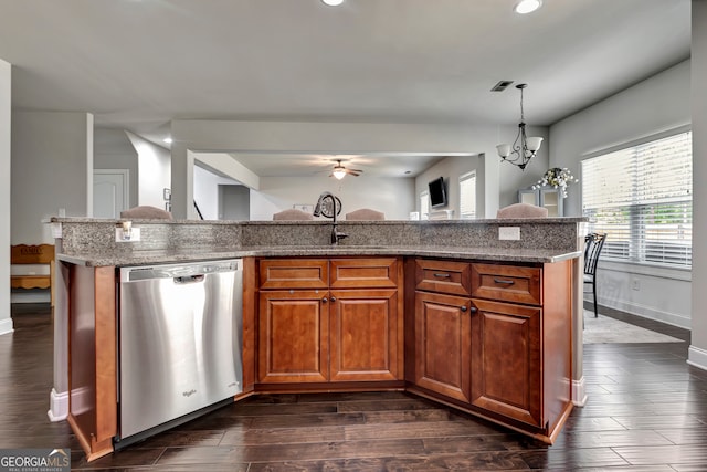 kitchen featuring dishwasher, dark wood-type flooring, pendant lighting, a center island with sink, and ceiling fan with notable chandelier