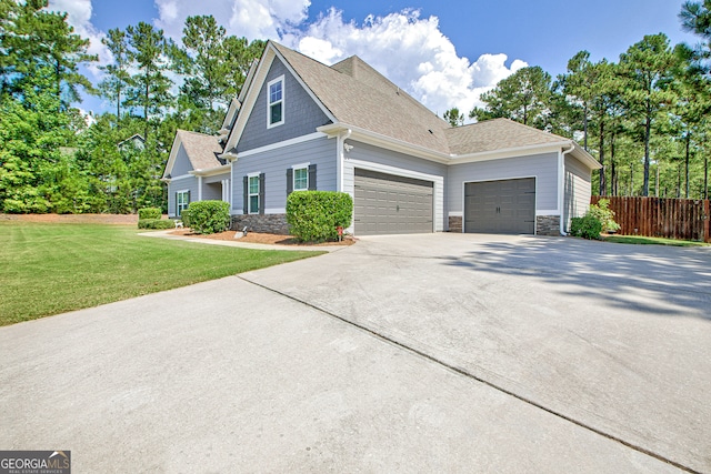 view of front of home with a front yard and a garage