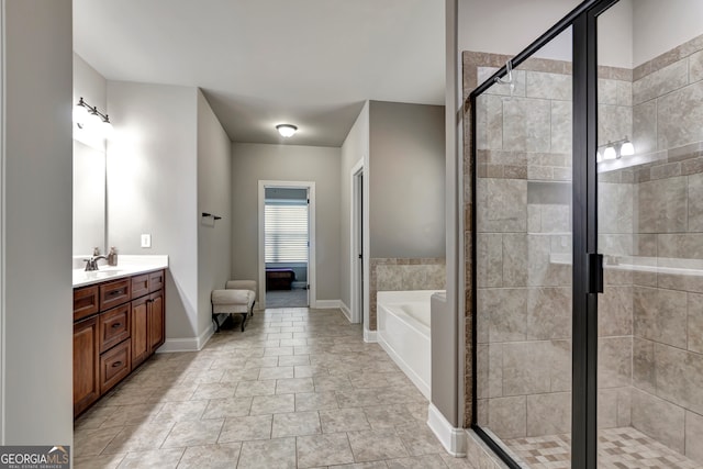 bathroom with vanity and separate shower and tub