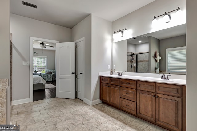 bathroom featuring ceiling fan, a shower with shower door, and vanity