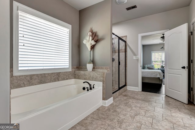 bathroom featuring ceiling fan and plus walk in shower