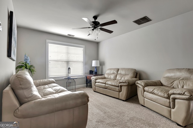 living room with light colored carpet and ceiling fan