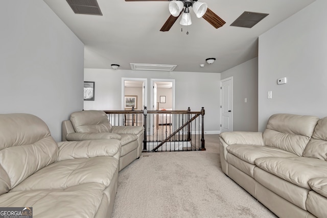 living room featuring ceiling fan and light colored carpet