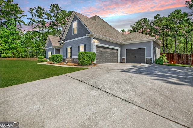 view of front of home featuring a lawn and a garage