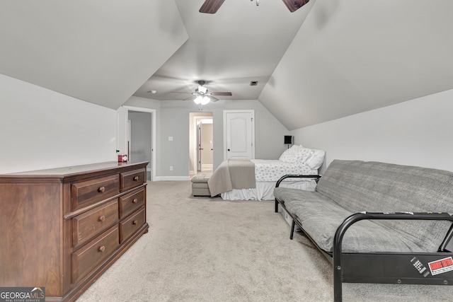 bedroom featuring connected bathroom, light carpet, ceiling fan, and vaulted ceiling