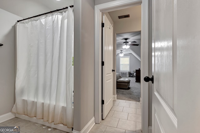 bathroom featuring tile patterned floors, ceiling fan, and shower / bathtub combination with curtain