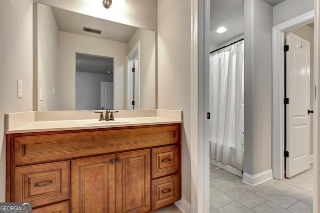 bathroom with tile patterned floors and vanity