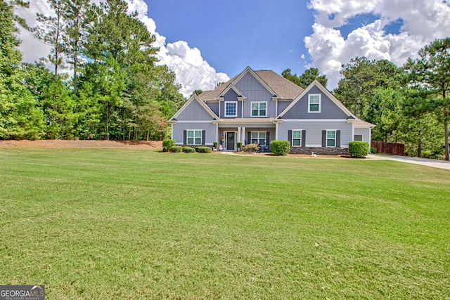 craftsman inspired home with a front lawn