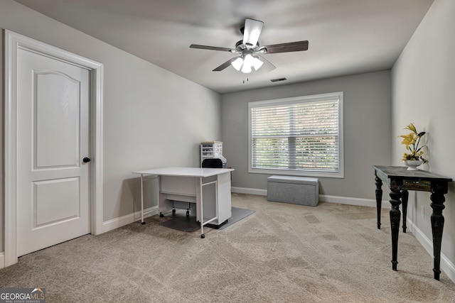 carpeted office space with ceiling fan