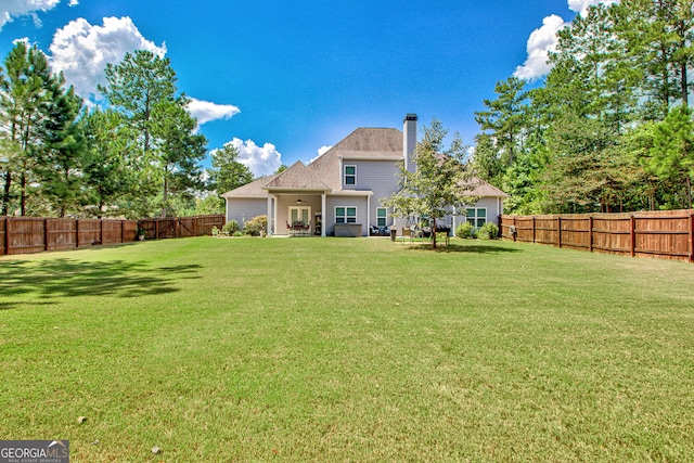 back of property featuring a yard