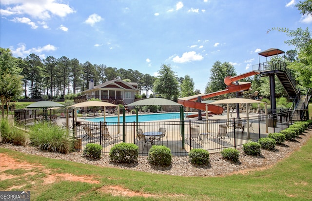 view of swimming pool with a water slide