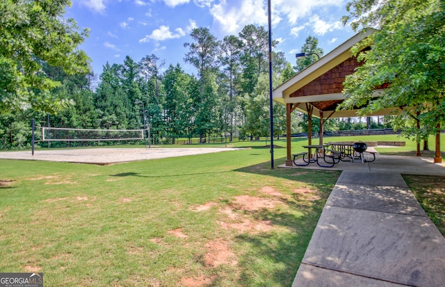 view of property's community with volleyball court and a lawn