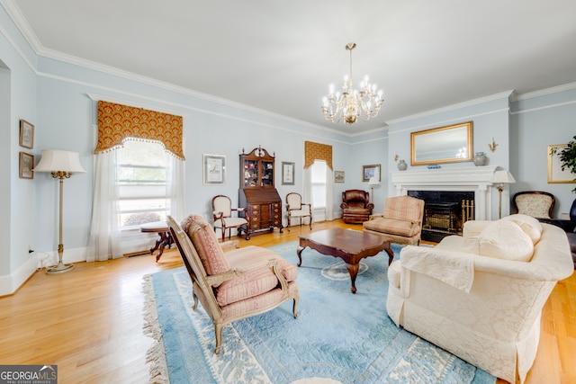 living room with light hardwood / wood-style flooring, ornamental molding, and a notable chandelier