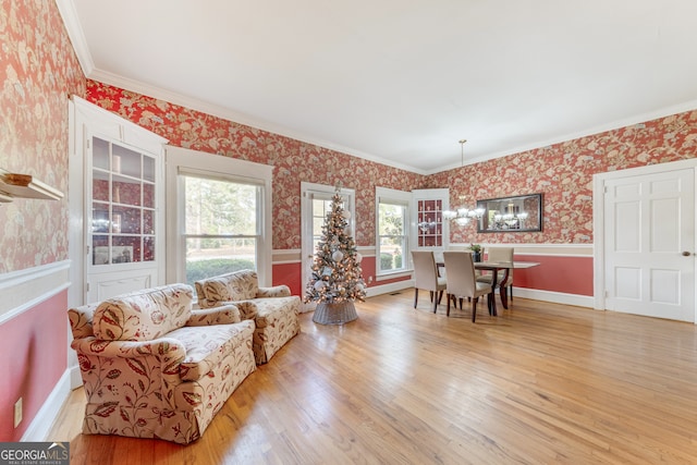 living room with light hardwood / wood-style floors and crown molding