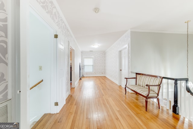 corridor with hardwood / wood-style flooring and ornamental molding