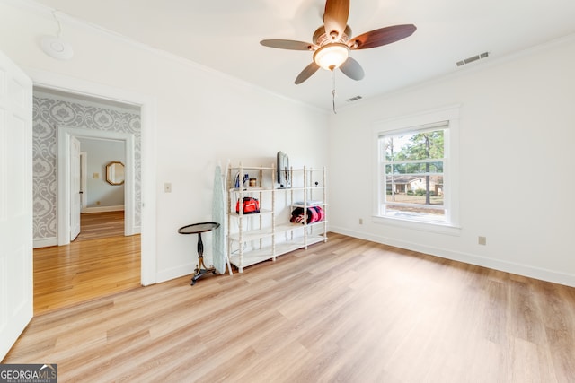 interior space featuring hardwood / wood-style floors, ceiling fan, and crown molding