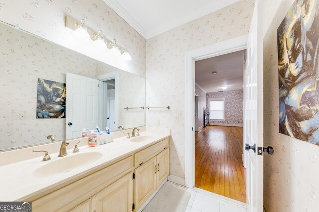 bathroom with crown molding, vanity, and hardwood / wood-style flooring