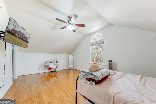 bedroom with ceiling fan, wood-type flooring, and lofted ceiling