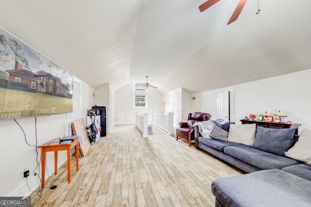 living room with hardwood / wood-style floors, ceiling fan, and vaulted ceiling