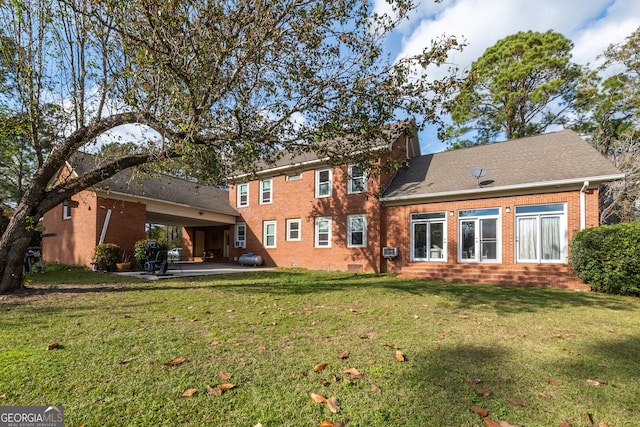 back of property featuring a patio and a lawn