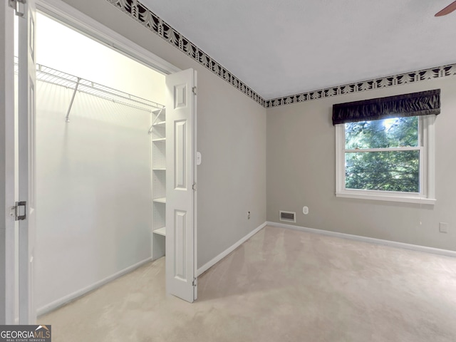 unfurnished bedroom featuring light colored carpet